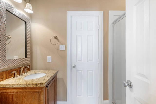 bathroom featuring an enclosed shower and vanity