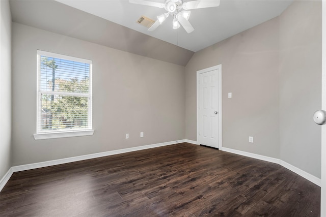 unfurnished room featuring lofted ceiling, baseboards, dark wood-style flooring, and ceiling fan