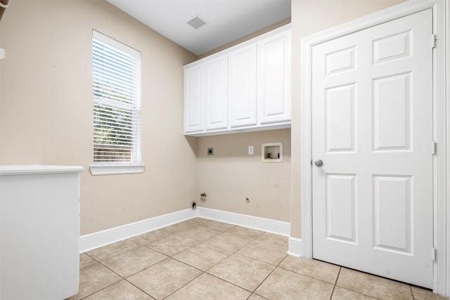 washroom with light tile patterned floors, visible vents, hookup for an electric dryer, cabinet space, and washer hookup