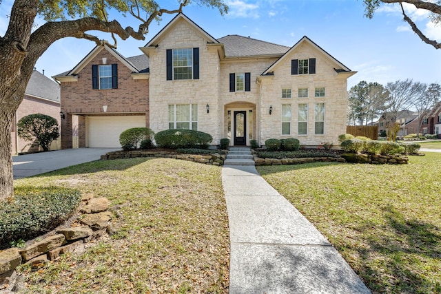 traditional home with a front lawn, concrete driveway, stone siding, and an attached garage