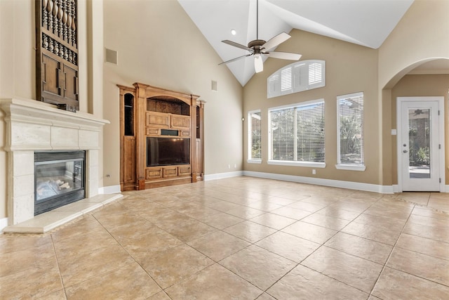 unfurnished living room with light tile patterned floors, visible vents, baseboards, and a high end fireplace