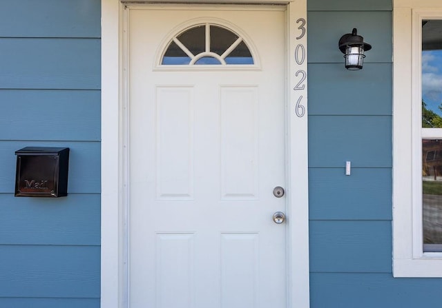 view of exterior entry with a garage