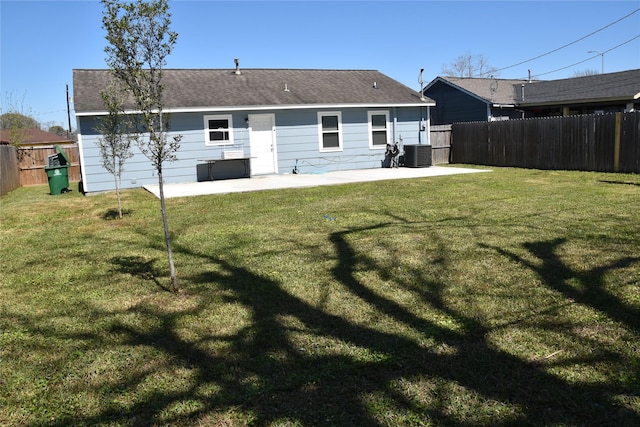 back of house featuring a yard, central AC unit, a fenced backyard, and a patio area