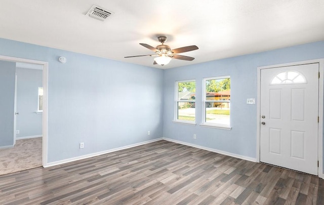 entryway featuring visible vents, baseboards, and wood finished floors