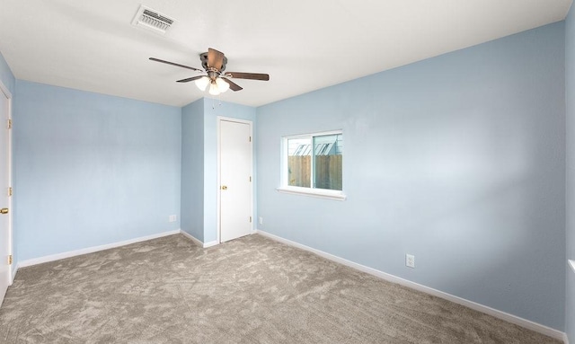 unfurnished bedroom featuring carpet flooring, baseboards, visible vents, and ceiling fan