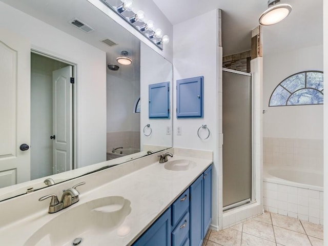 bathroom featuring visible vents, a stall shower, and a sink