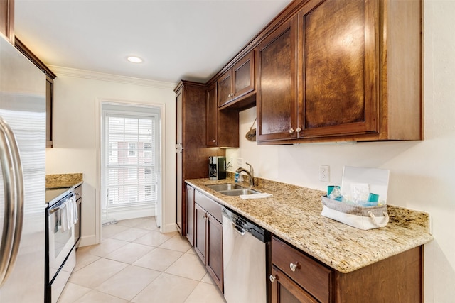 kitchen featuring crown molding, light stone countertops, light tile patterned floors, stainless steel appliances, and a sink