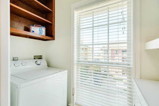 laundry room with washer / dryer, a wealth of natural light, and laundry area