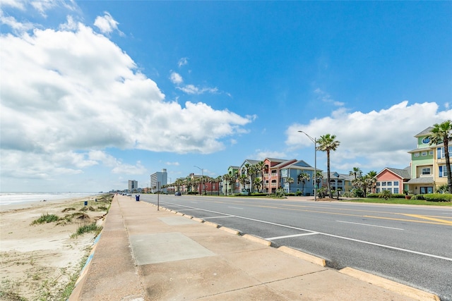 view of street featuring curbs, street lighting, and sidewalks