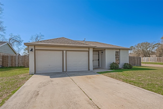 ranch-style house featuring an attached garage, a front yard, and fence