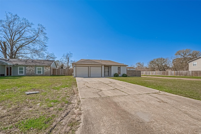 view of front facade with an attached garage, concrete driveway, a front yard, and fence