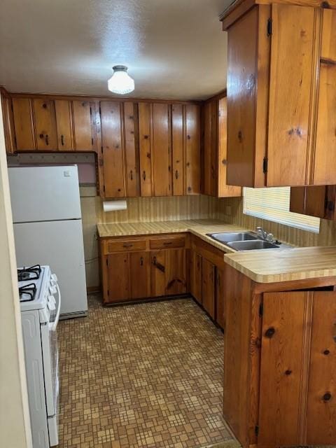 kitchen featuring white appliances and brown cabinetry