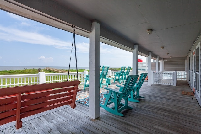 wooden terrace featuring a water view