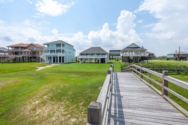 view of dock with a lawn