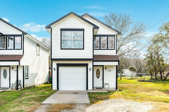 view of front of house with a front lawn, an attached garage, and a shingled roof