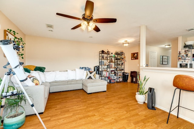 living area featuring visible vents, ceiling fan, and light wood-style floors