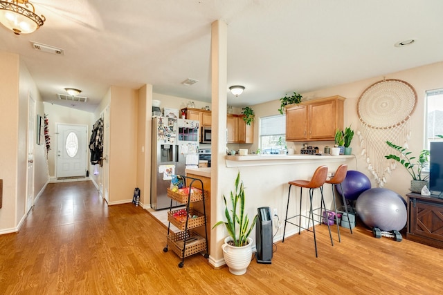 kitchen with visible vents, stainless steel appliances, and light wood-style floors