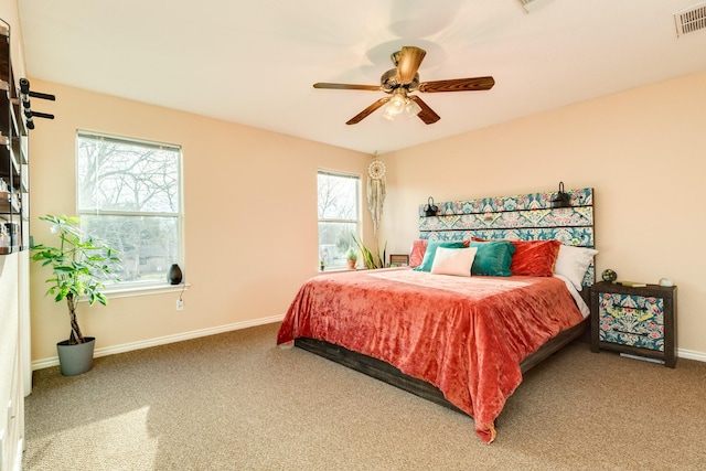 bedroom with carpet flooring, baseboards, visible vents, and ceiling fan