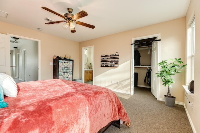 bedroom featuring a ceiling fan, carpet, visible vents, baseboards, and a walk in closet