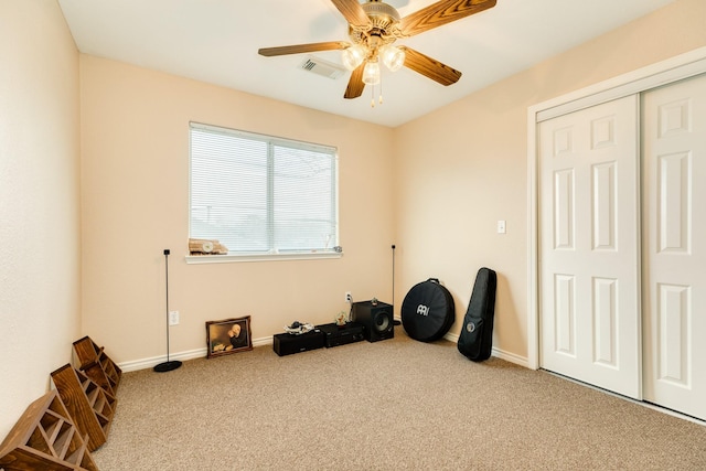 miscellaneous room featuring a ceiling fan, baseboards, visible vents, and carpet floors