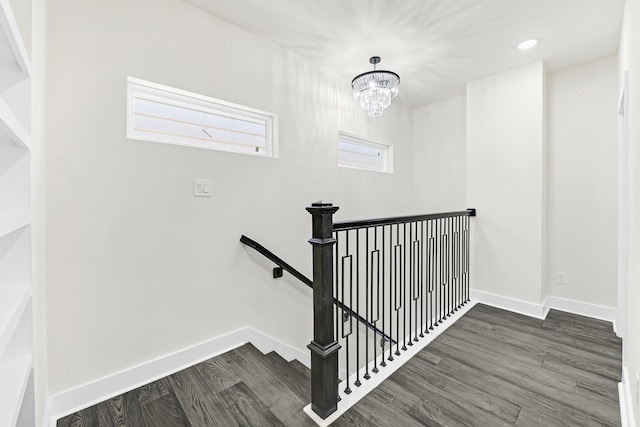 stairs featuring a notable chandelier, recessed lighting, baseboards, and wood finished floors