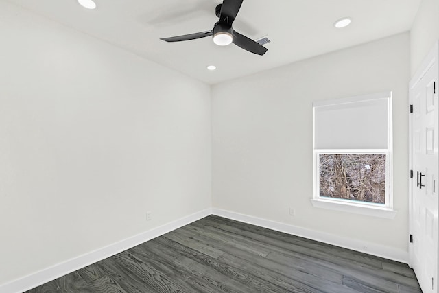 spare room featuring recessed lighting, visible vents, baseboards, and dark wood finished floors