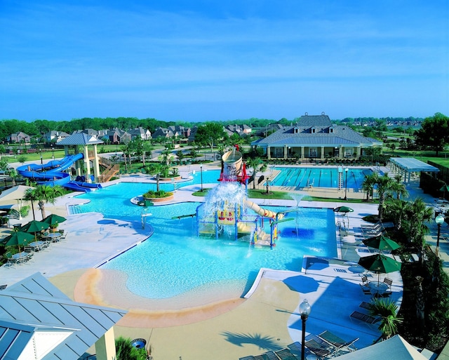 community pool with a water slide and a water play area