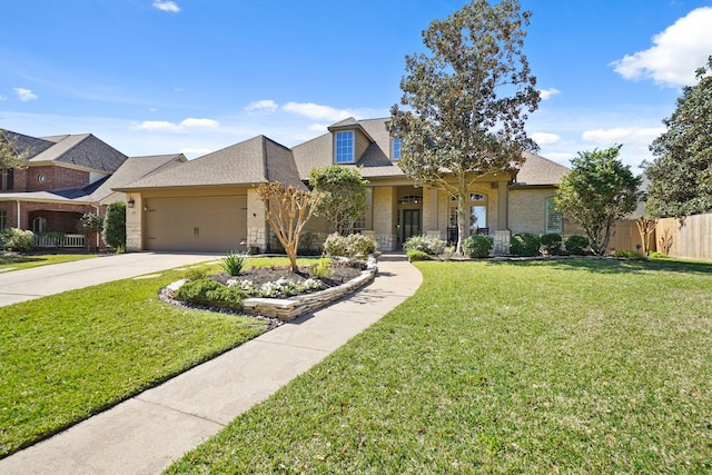 view of front of house featuring driveway, a front lawn, fence, an attached garage, and brick siding