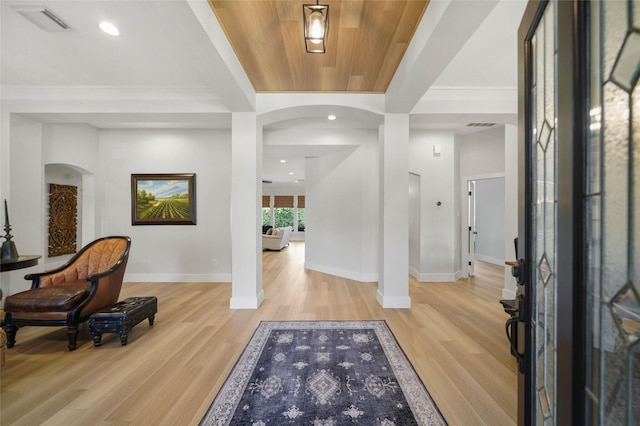 foyer entrance with baseboards, visible vents, recessed lighting, arched walkways, and light wood-style floors