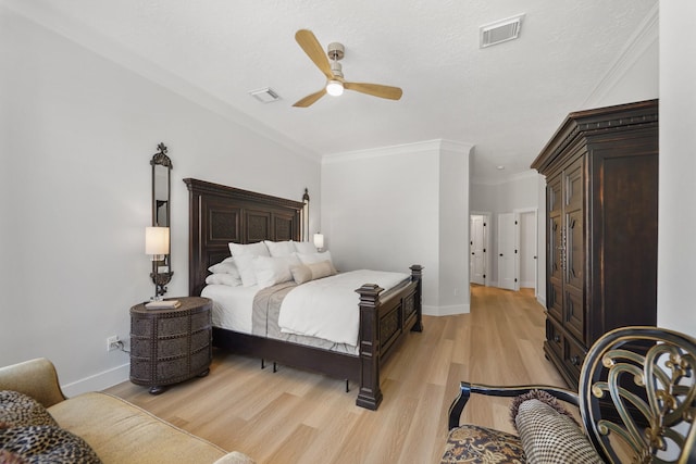 bedroom with light wood finished floors, visible vents, and baseboards