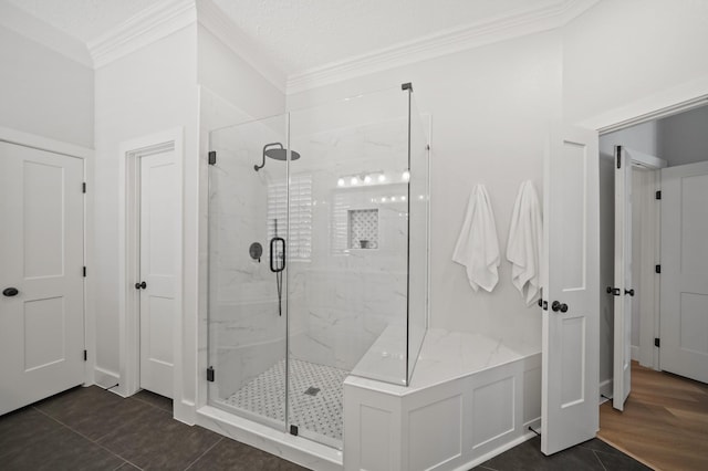 full bathroom with tile patterned floors, a marble finish shower, and crown molding