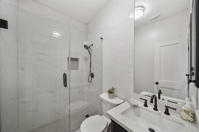 full bath featuring visible vents, a stall shower, toilet, and vanity