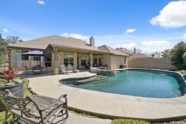 view of pool featuring a patio, a pool with connected hot tub, and fence