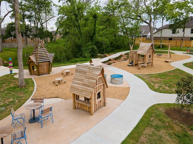 exterior space featuring a playground, a patio, and fence