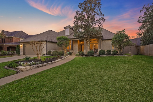 view of front facade with a front lawn, fence, french doors, concrete driveway, and a garage