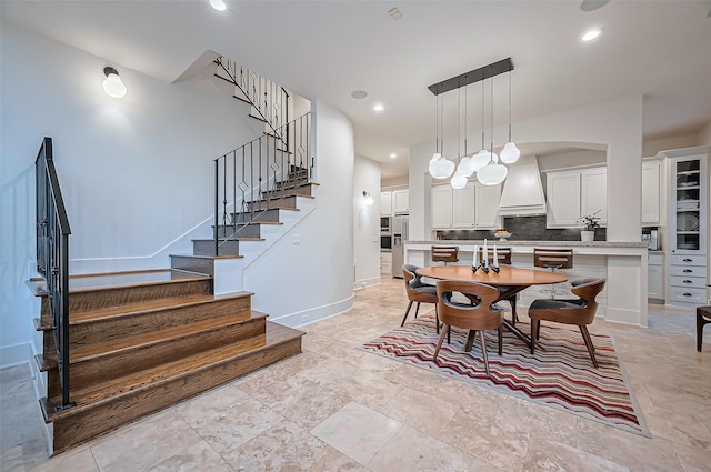 dining space with recessed lighting, baseboards, and stairs