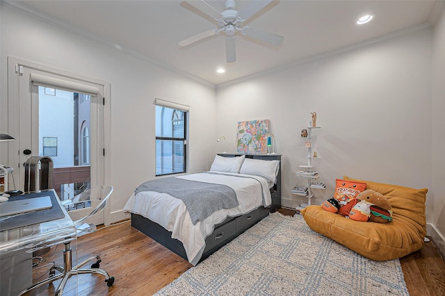 bedroom featuring recessed lighting, wood finished floors, baseboards, and ornamental molding