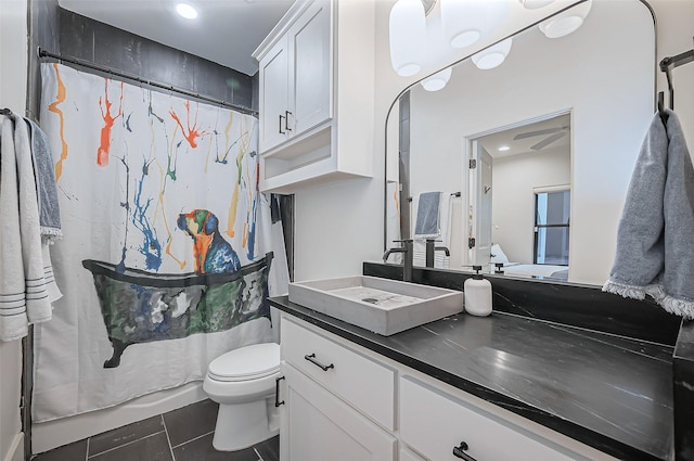 full bathroom with a shower with curtain, toilet, tile patterned flooring, ceiling fan, and vanity