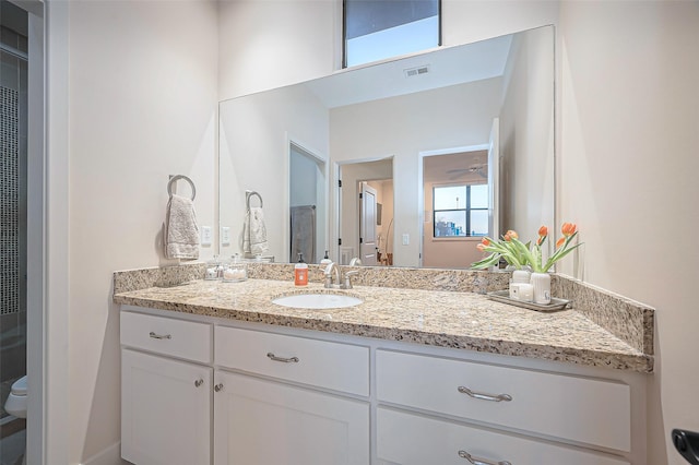 bathroom with visible vents, toilet, and vanity