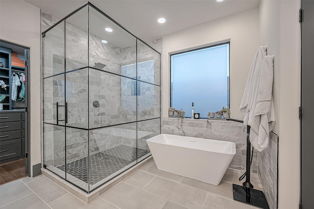 full bath with tile patterned floors, a soaking tub, recessed lighting, and a stall shower