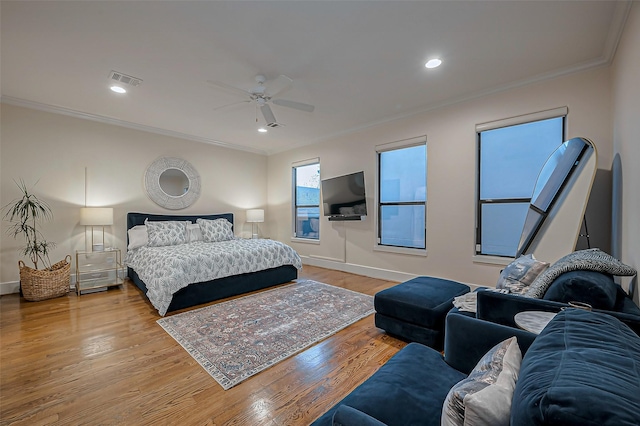 bedroom featuring crown molding, recessed lighting, wood finished floors, and baseboards