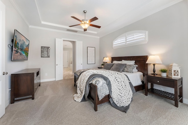 bedroom with visible vents, ornamental molding, a tray ceiling, and carpet floors