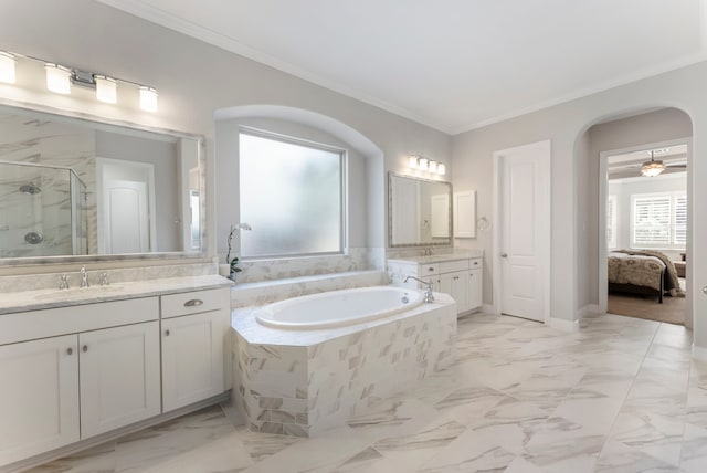 ensuite bathroom with crown molding, a bath, a stall shower, and a sink