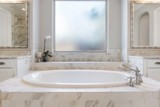 bathroom featuring a bath and vanity