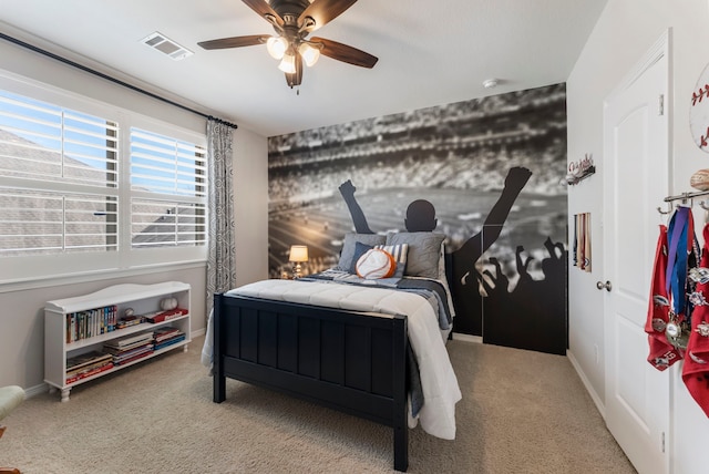 bedroom featuring visible vents, a ceiling fan, baseboards, and carpet floors