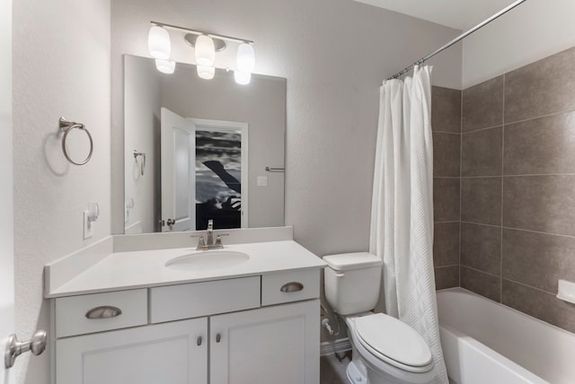 full bath featuring toilet, vanity, a textured wall, and shower / bathtub combination with curtain