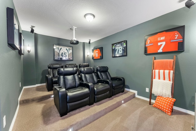 home theater with a textured ceiling, baseboards, and carpet floors