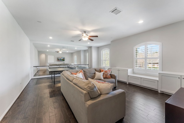 living area with dark wood finished floors, recessed lighting, visible vents, and a ceiling fan