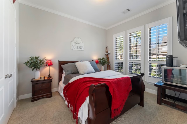 carpeted bedroom featuring visible vents, baseboards, and crown molding