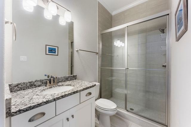 bathroom featuring vanity, toilet, a stall shower, and crown molding